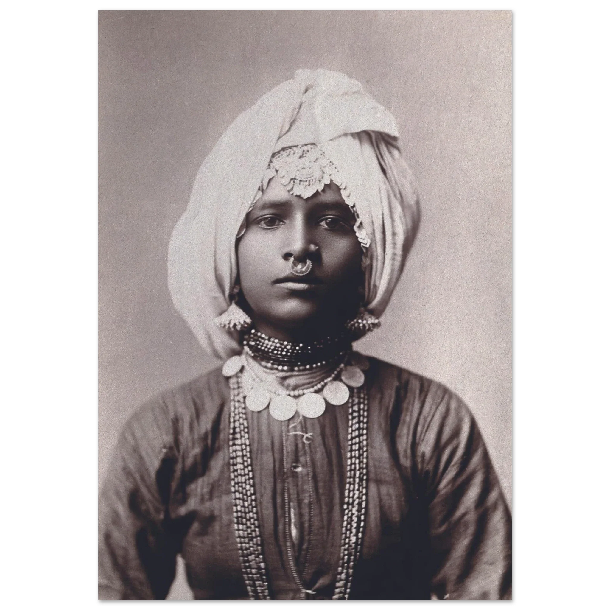 Sepia portrait of a Hindu princess wearing traditional attire and ornate jewelry, exuding regal poise.
