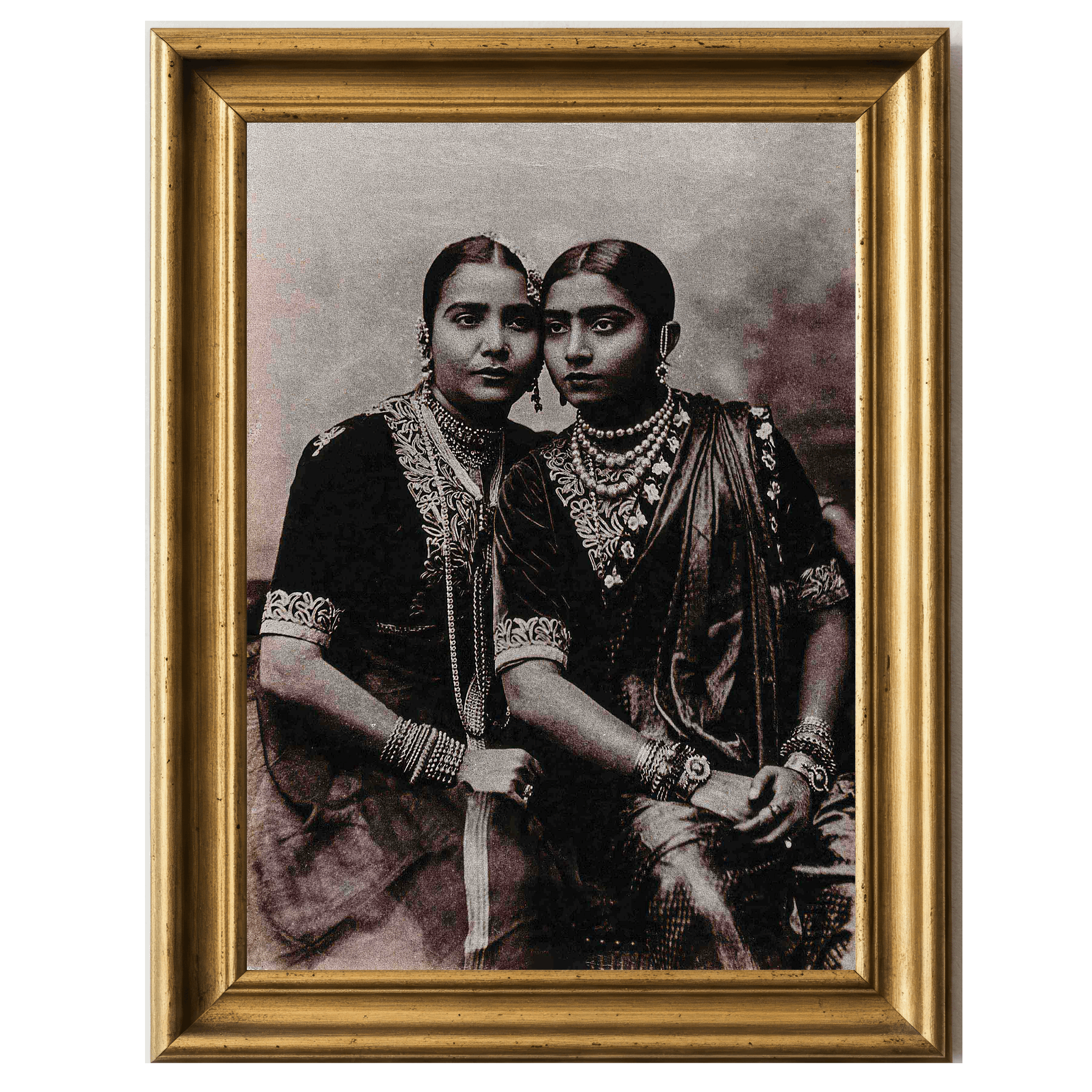Sepia-toned photograph of two Nautch dancers in traditional embroidered garments and ornate jewelry, seated closely
