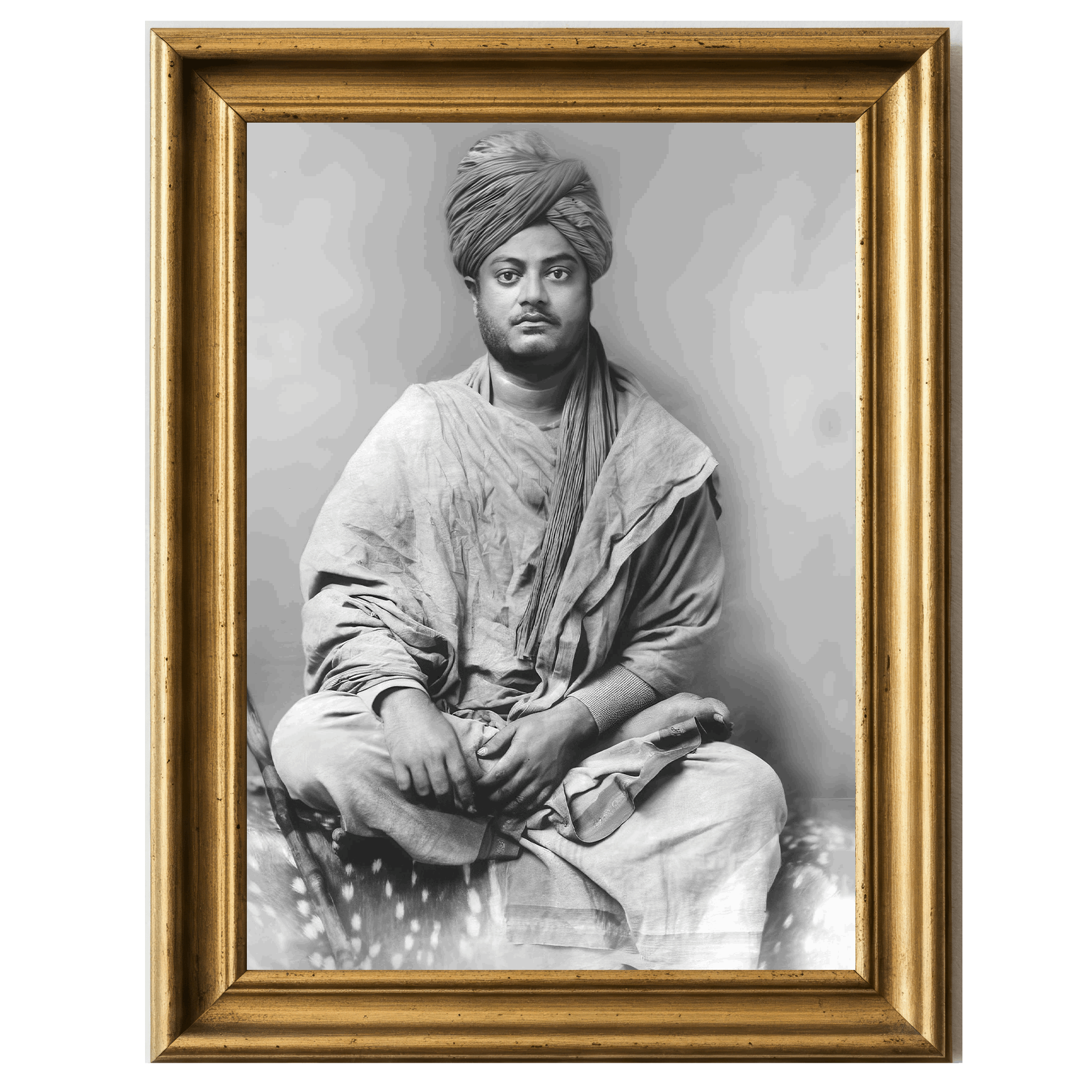 Black-and-white photograph of Swami Vivekananda seated cross-legged, clad in robes and turban