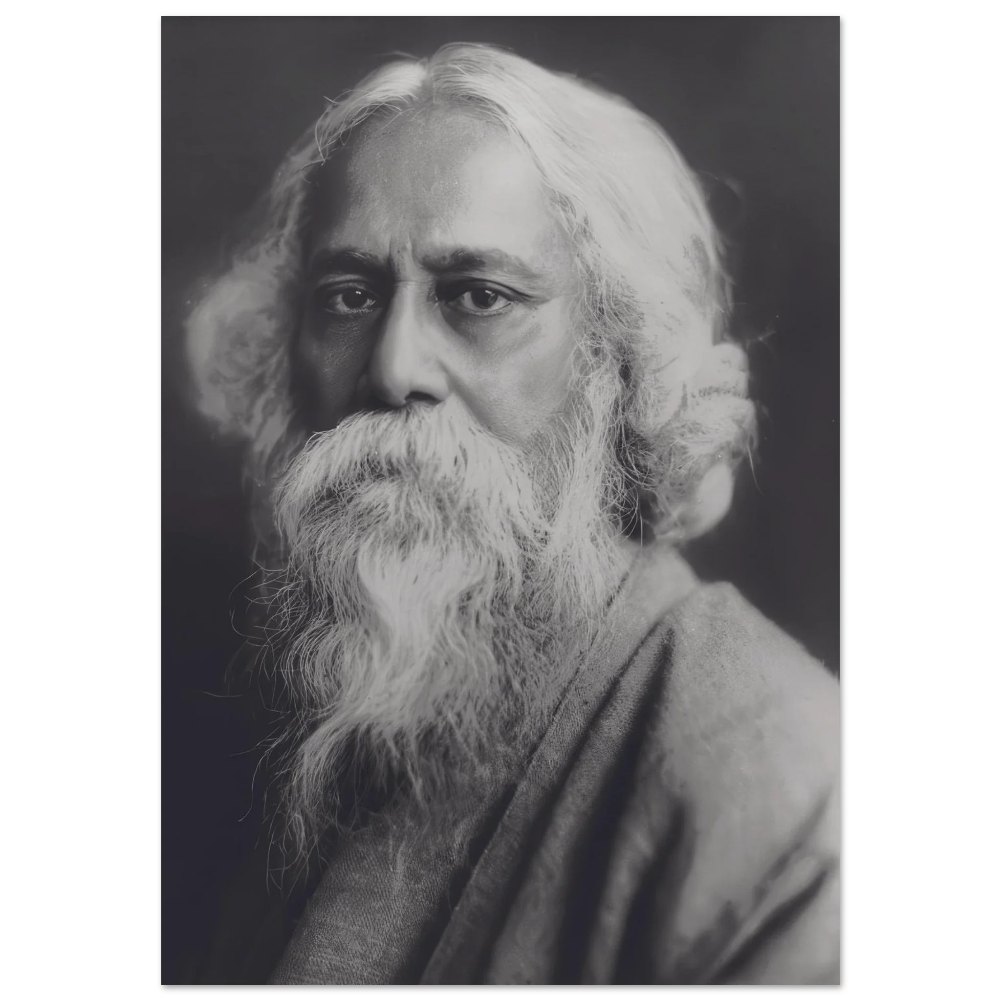Black and white photographic portrait of Rabindranath Tagore with flowing beard and contemplative expression.