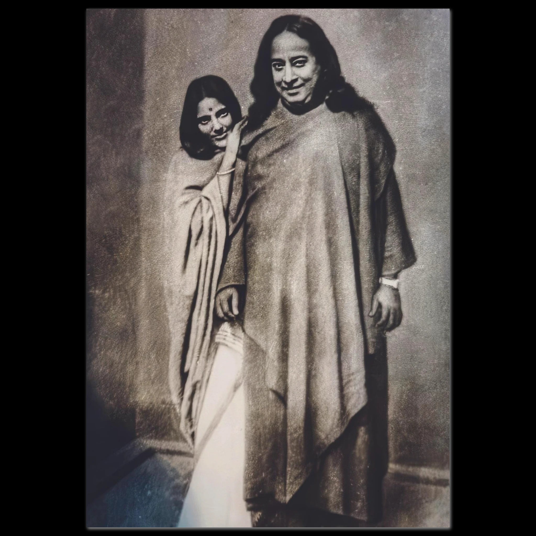 Black-and-white photo of Paramahansa Yogananda and Anandamayi Ma standing together.
